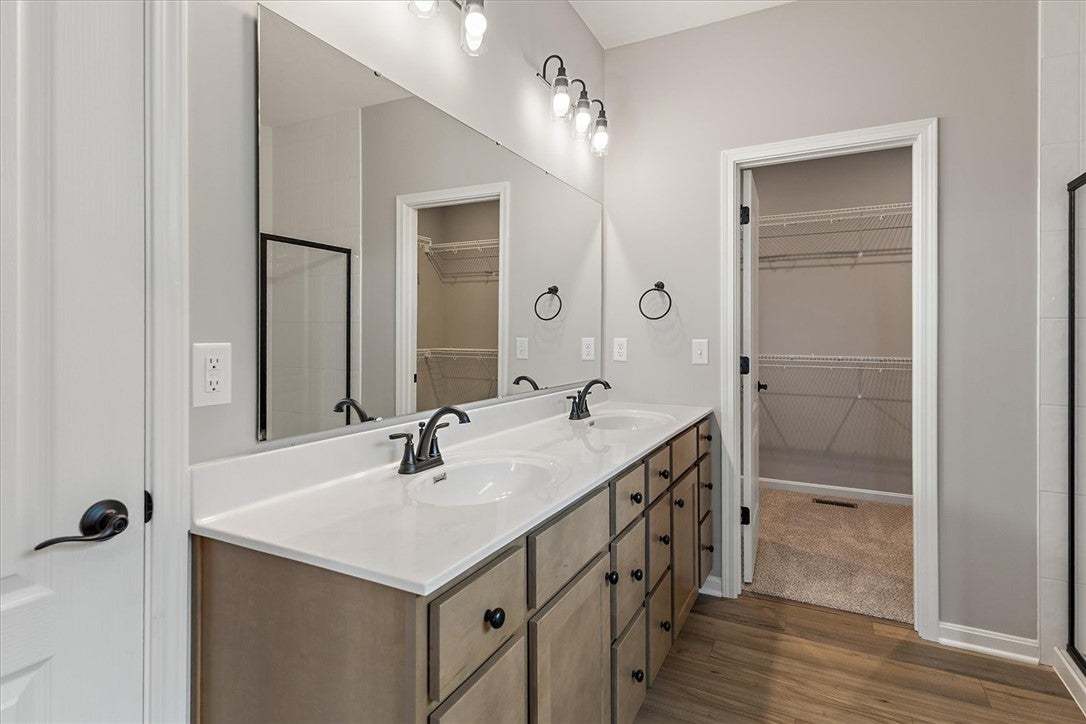 Dual vanities with sleek fixtures and ample storag