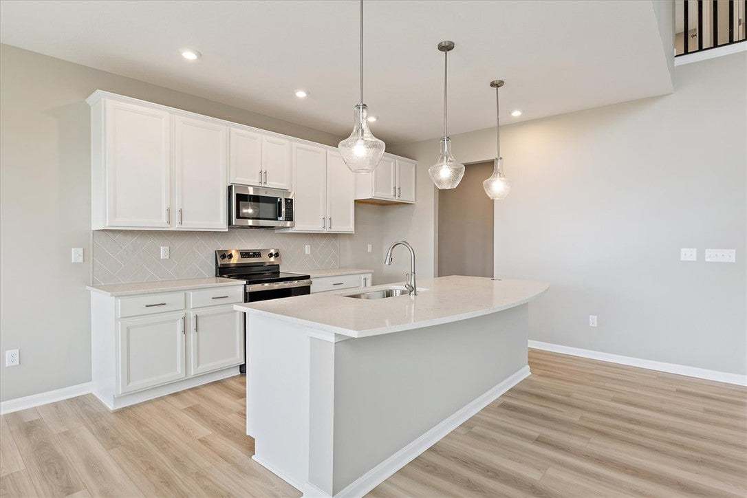 This bright and airy kitchen boasts sleek countert