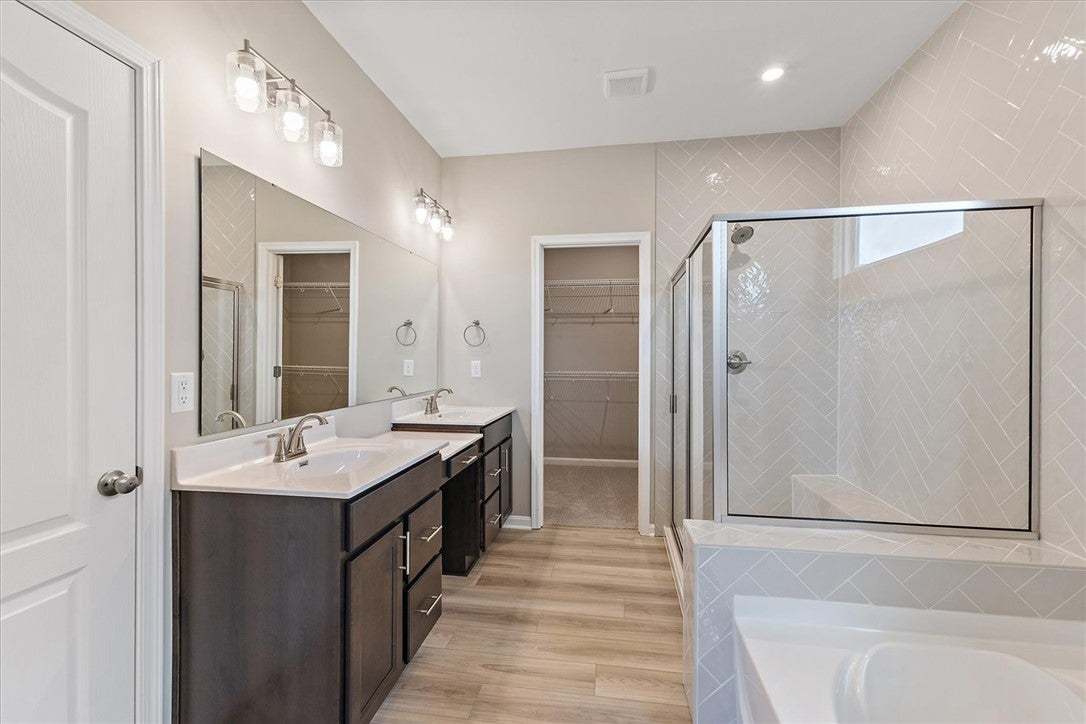 This spacious bathroom offers dual vanities, a lar