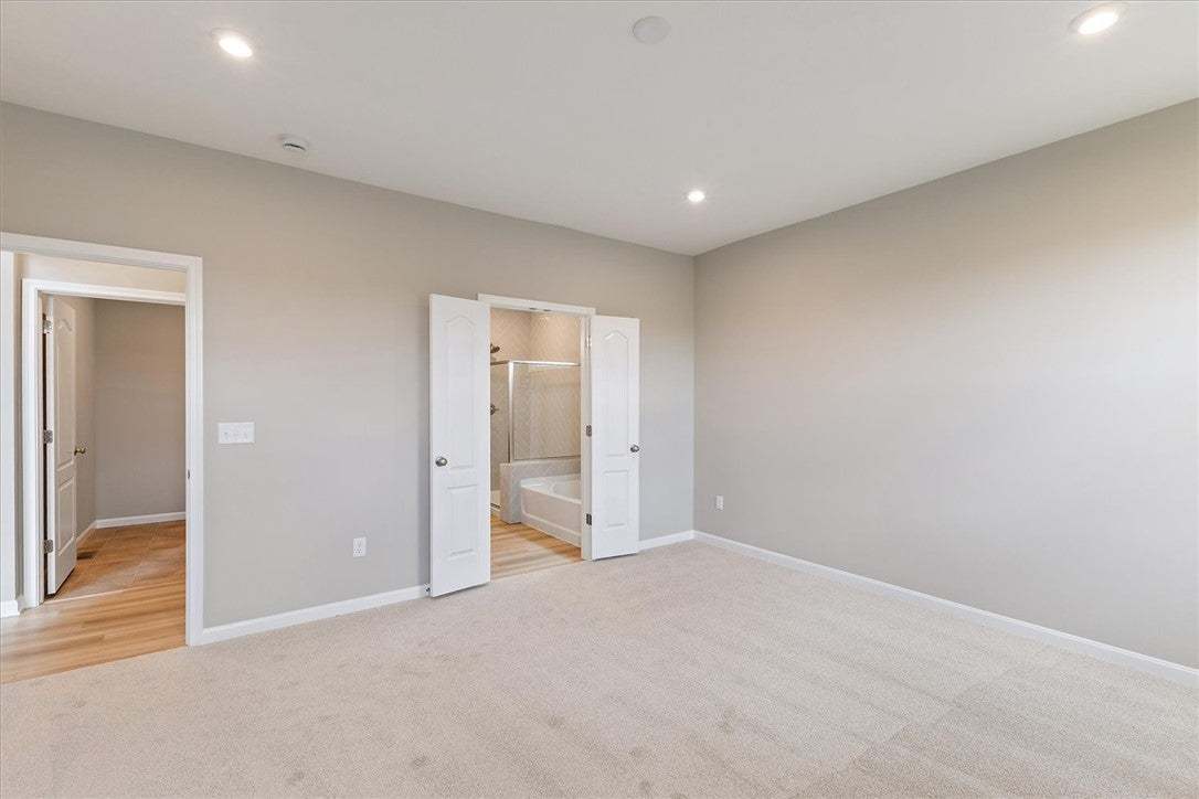 This primary bedroom offers ample space, recessed