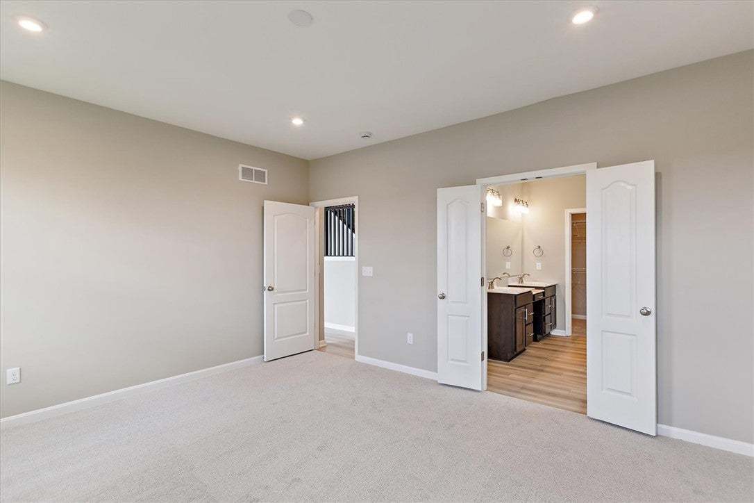 This spacious bedroom offers direct access to a we