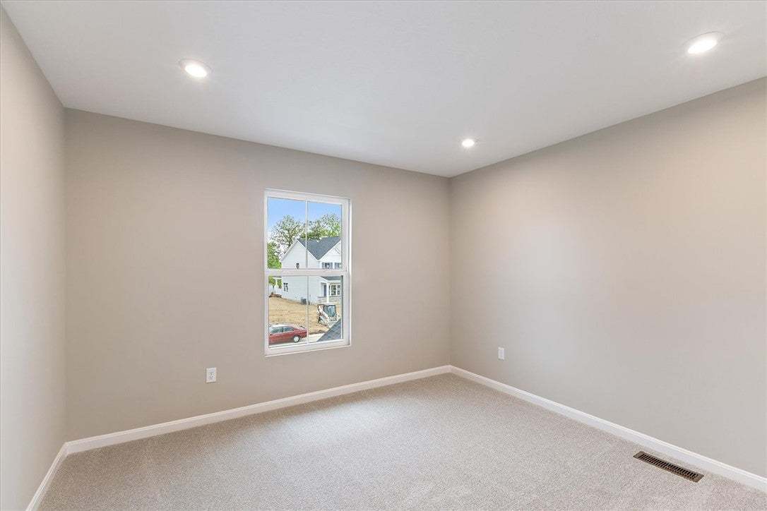 This inviting bedroom features soft carpeting and
