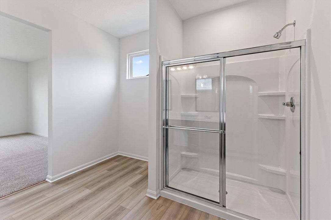 A well-appointed shower with glass enclosure and s