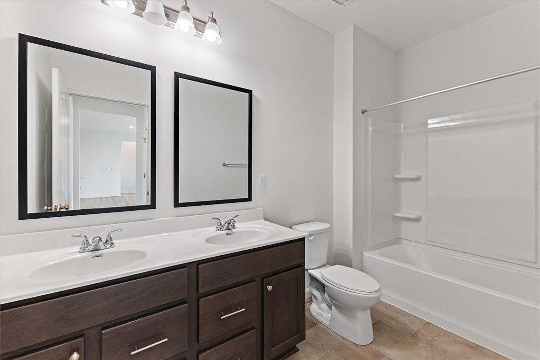 A well-appointed bathroom offers a double vanity a