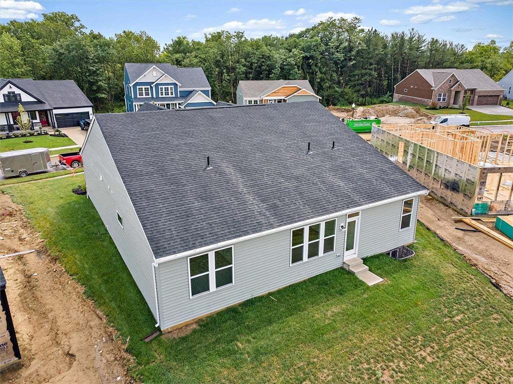 A newly constructed home with a pristine lawn awai