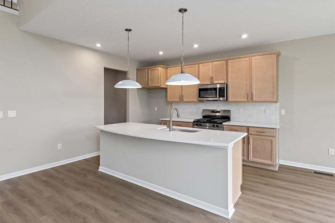 Gleaming stone countertops and a spacious central
