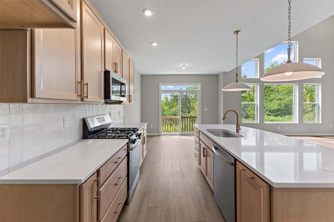 Natural light pours across the wood floors and sto