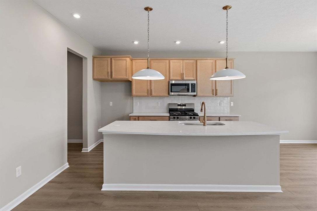 Smooth wood floors and stone countertops anchor th
