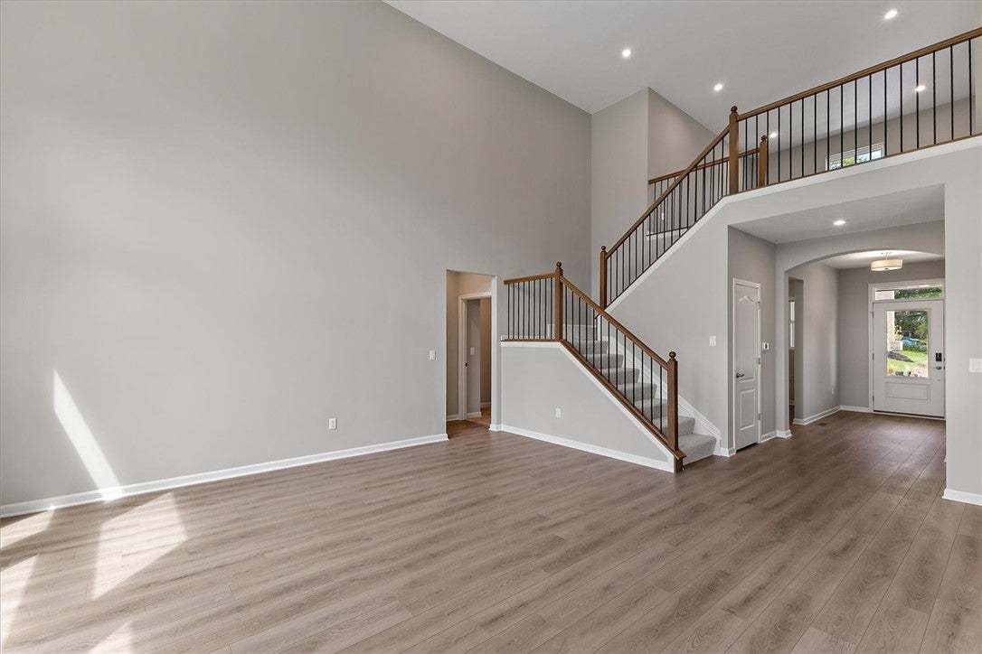 Soaring ceilings and a striking staircase define t