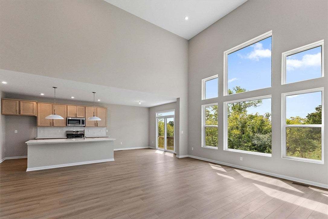 Towering windows frame tranquil nature views in th