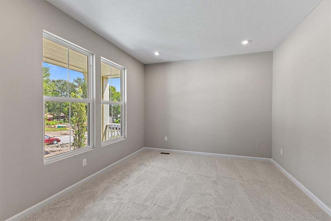 Plush carpeting anchors this versatile room under