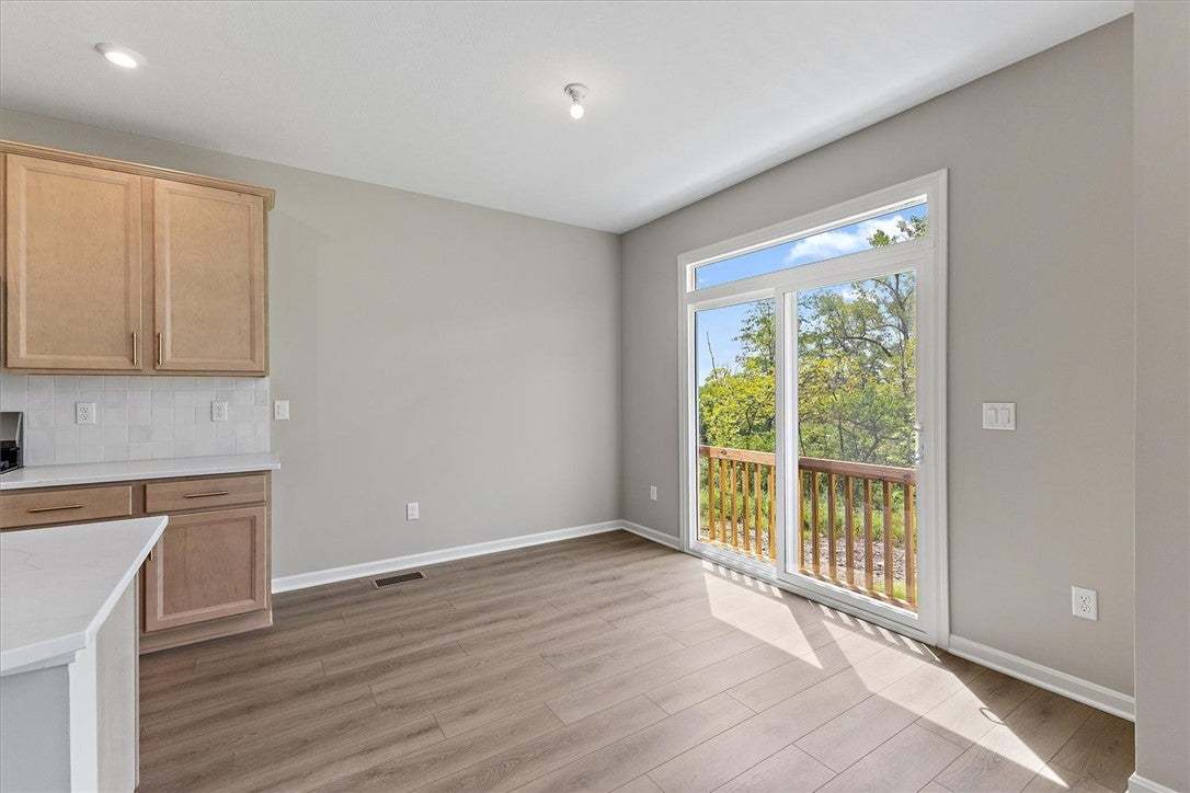 Sliding glass doors lead to a wooden deck overlook