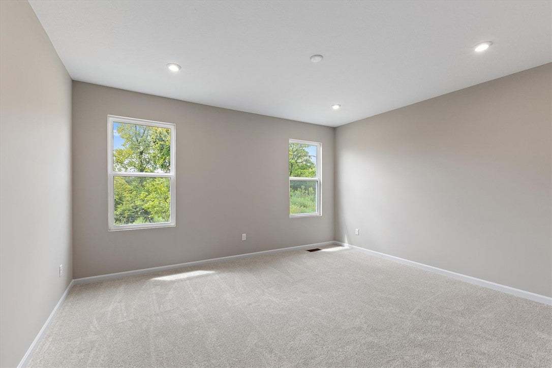 Recessed lighting and soft carpeting create a sere
