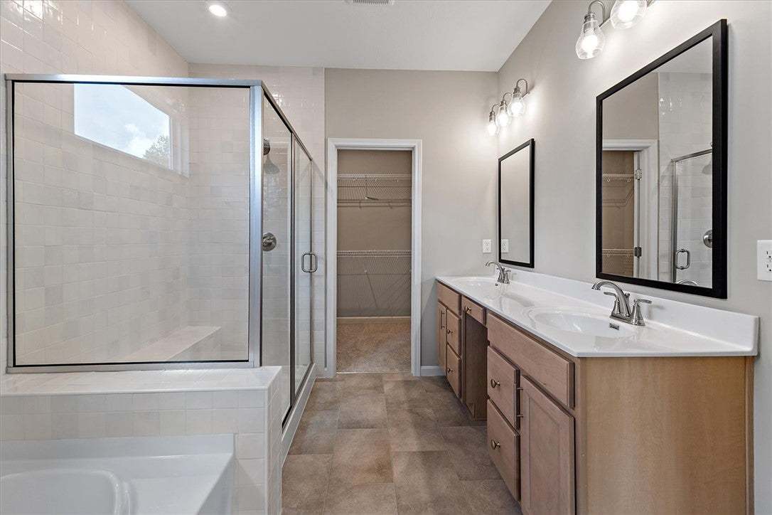 Double vanities and a large glass-enclosed shower