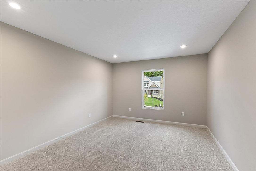 Recessed lighting illuminates plush neutral carpet