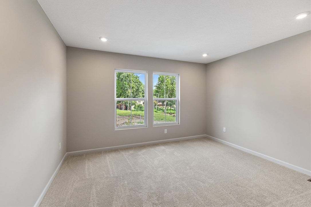 Recessed lighting and soft carpeting create a tran