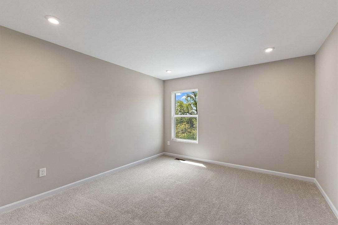 Recessed lighting illuminates plush carpeting and