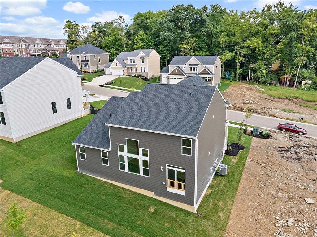 Manicured lawns and neat shingle roofs define this