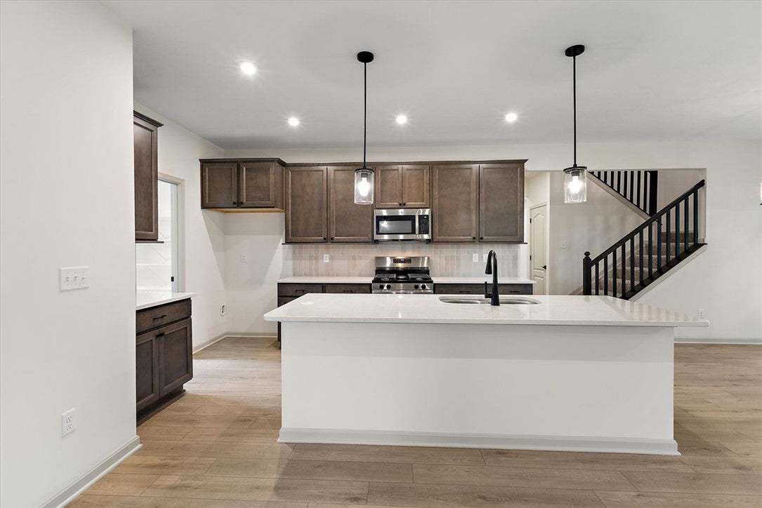 An open floor plan kitchen highlights a generous c