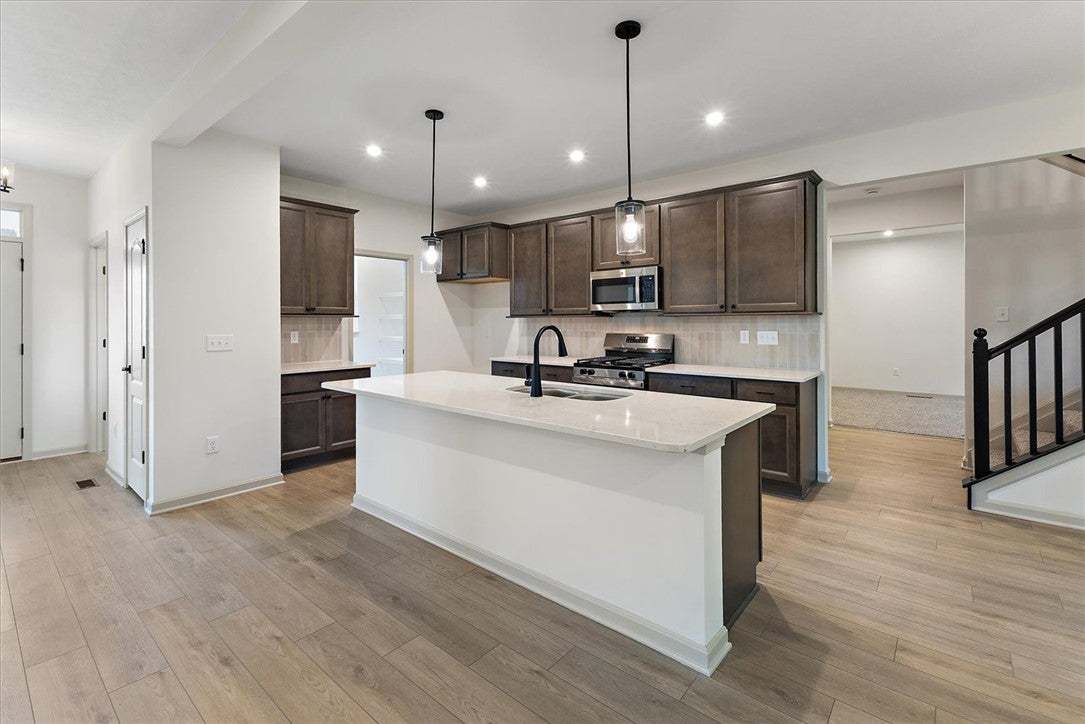 Rich wood cabinetry contrasts beautifully with pal