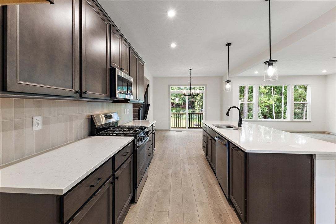 Rich dark cabinetry and pristine stone countertops