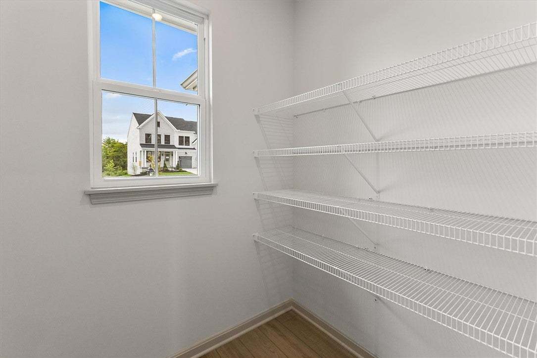 Functional shelving and a bright window line this