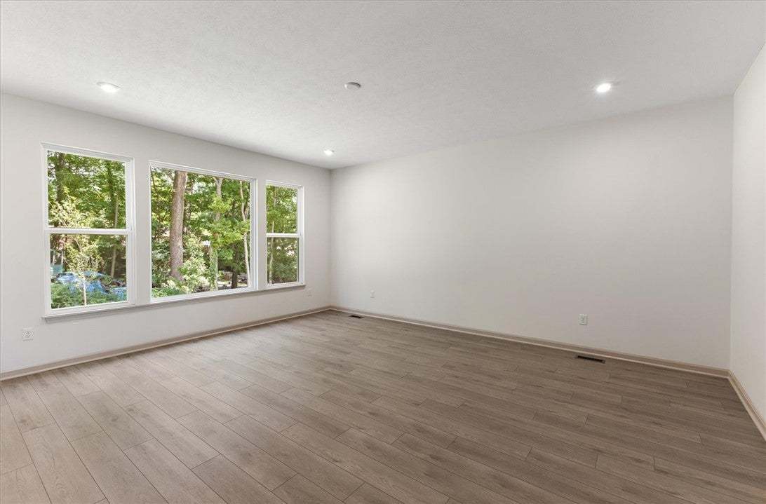 Plank flooring and recessed lighting define this v