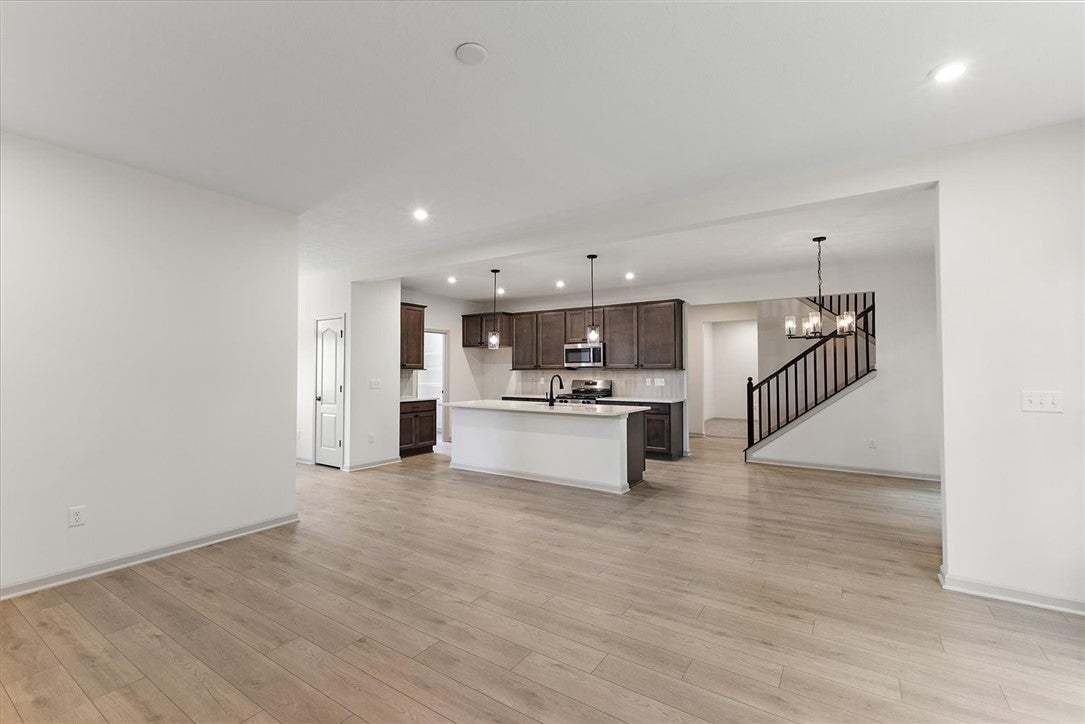 Smooth wood-look flooring connects this versatile