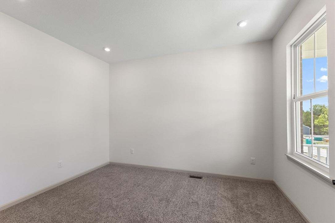 Recessed lighting illuminates neutral walls and pl