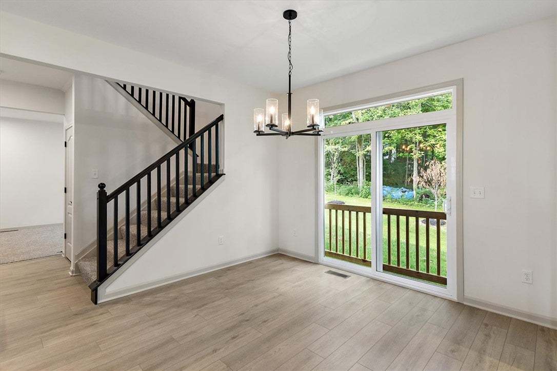 Plank flooring and a sliding glass door accent thi