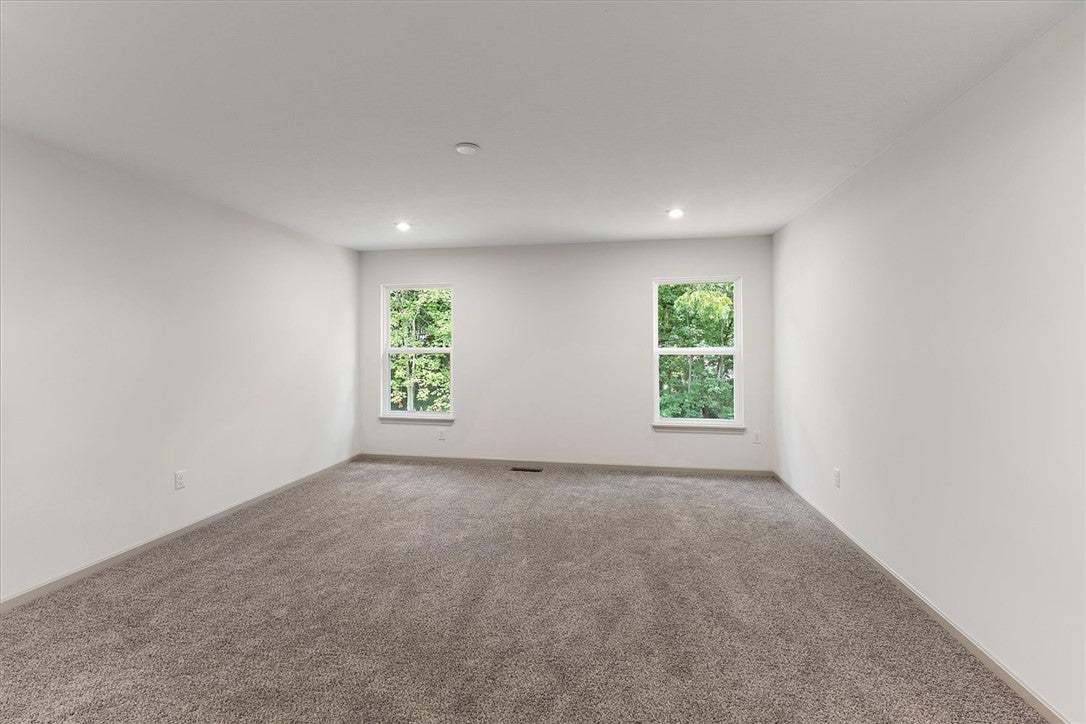 Plush carpeting anchors this clean-lined space ove