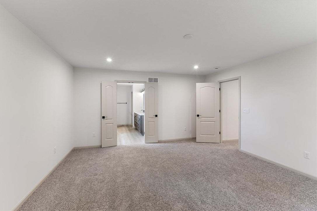 Recessed lighting illuminates this comfortable bed