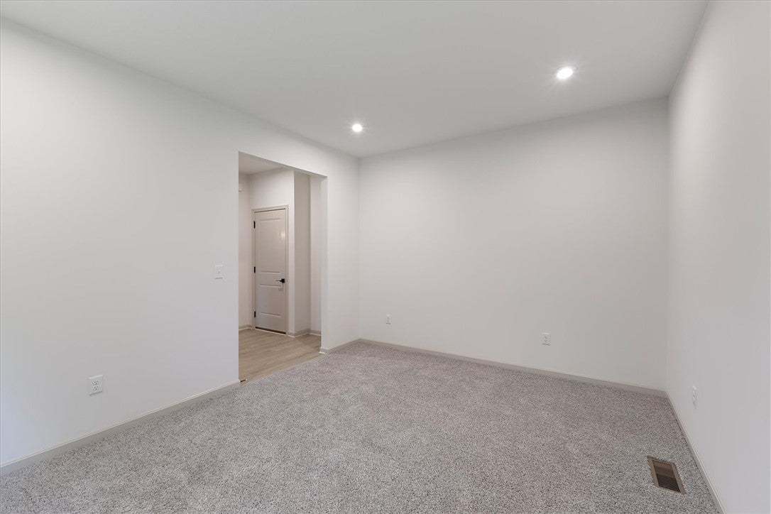 Recessed lighting illuminates clean white walls an