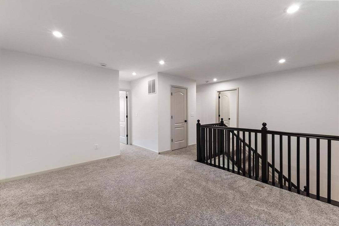 Recessed lighting illuminates this upper landing f