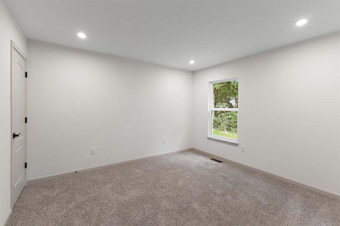 Recessed lighting and soft carpeting create a sere