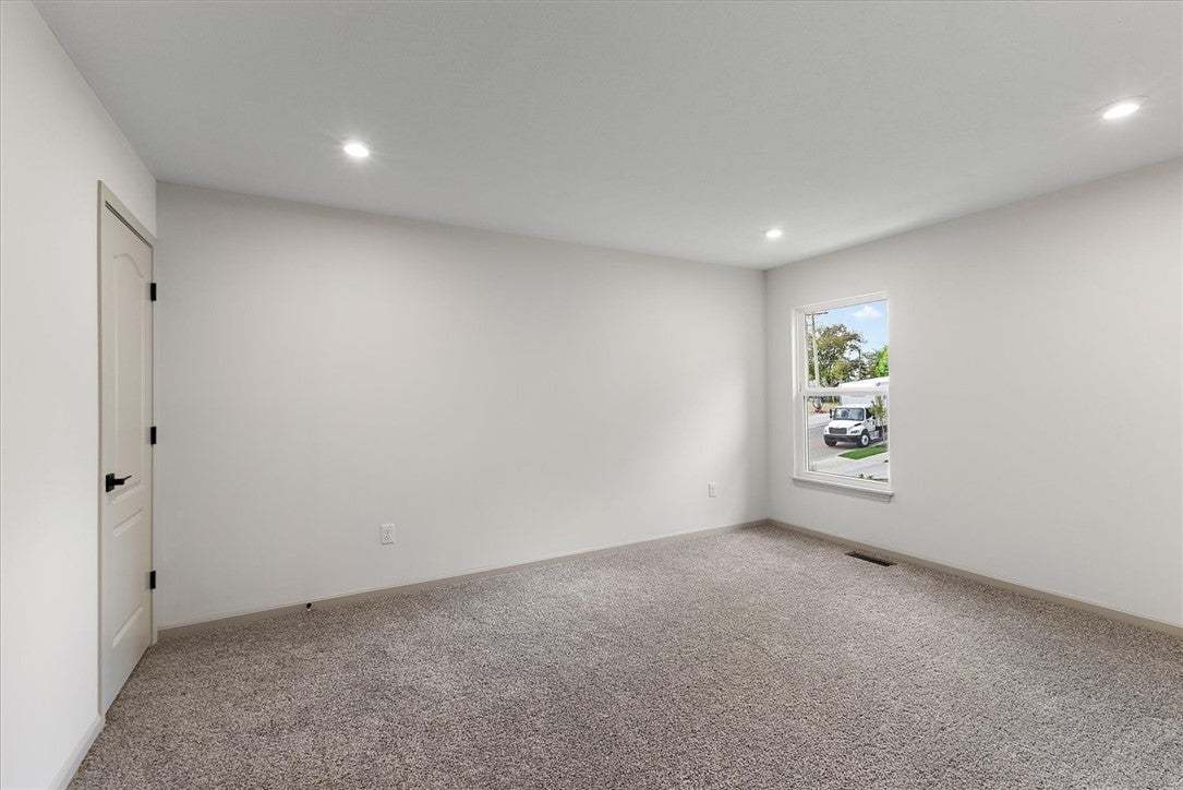 Recessed lighting and soft carpeting create a sere