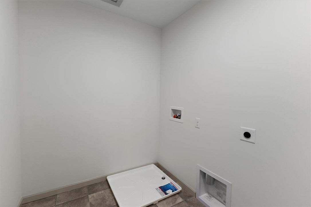 Tiled flooring and clean white walls anchor this f