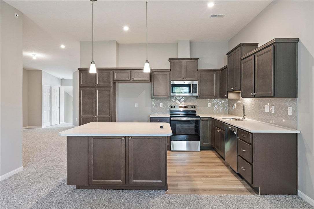 Gleaming stone countertops and dark wood cabinetry
