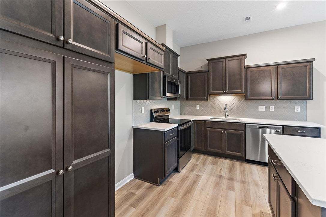 Rich dark cabinetry pairs beautifully with light c