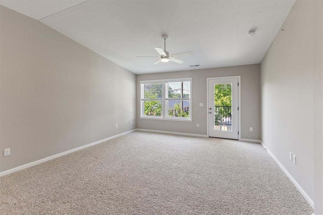 Plush carpeting and outdoor access define this ver