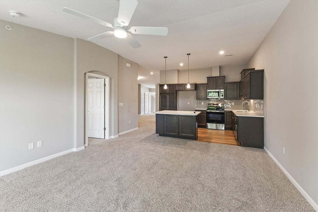 An open floor plan seamlessly connects the carpete