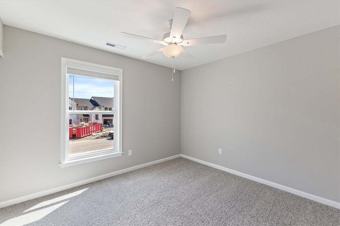 Soft carpeting pairs with a bright window overlook