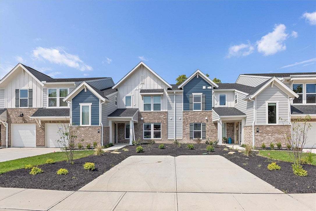 Crisp gables, brick accents, and a wide concrete d