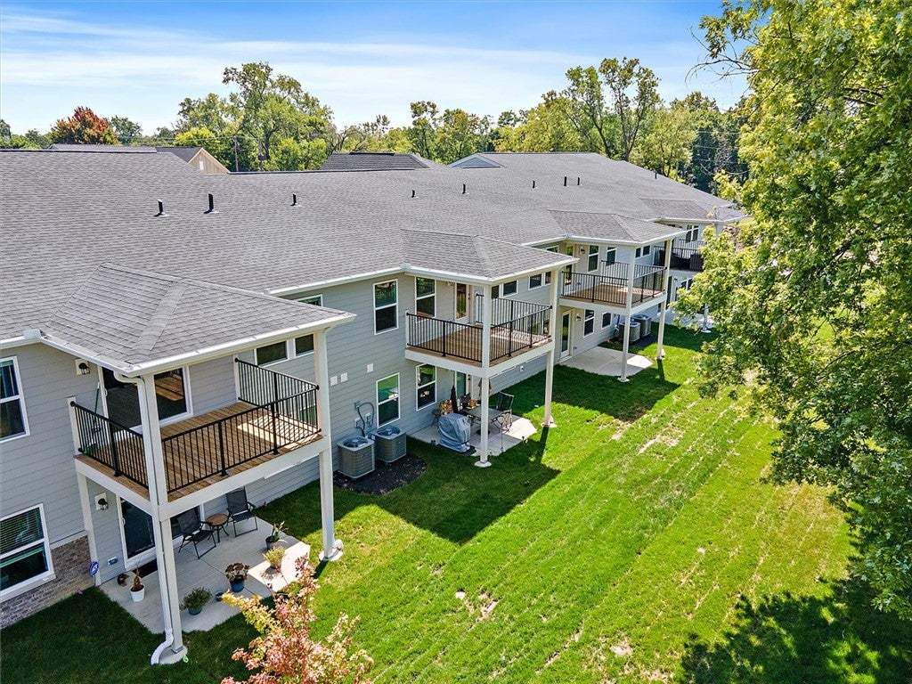 Multi-level balconies overlook a manicured lawn fr