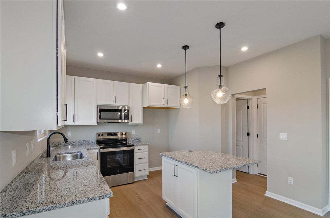 Polished stone countertops pair with clean cabinet