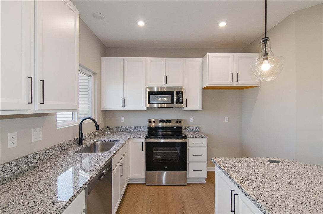 Gleaming stone countertops and modern cabinetry de