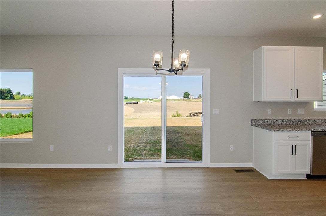Sliding glass doors open to backyard views from th