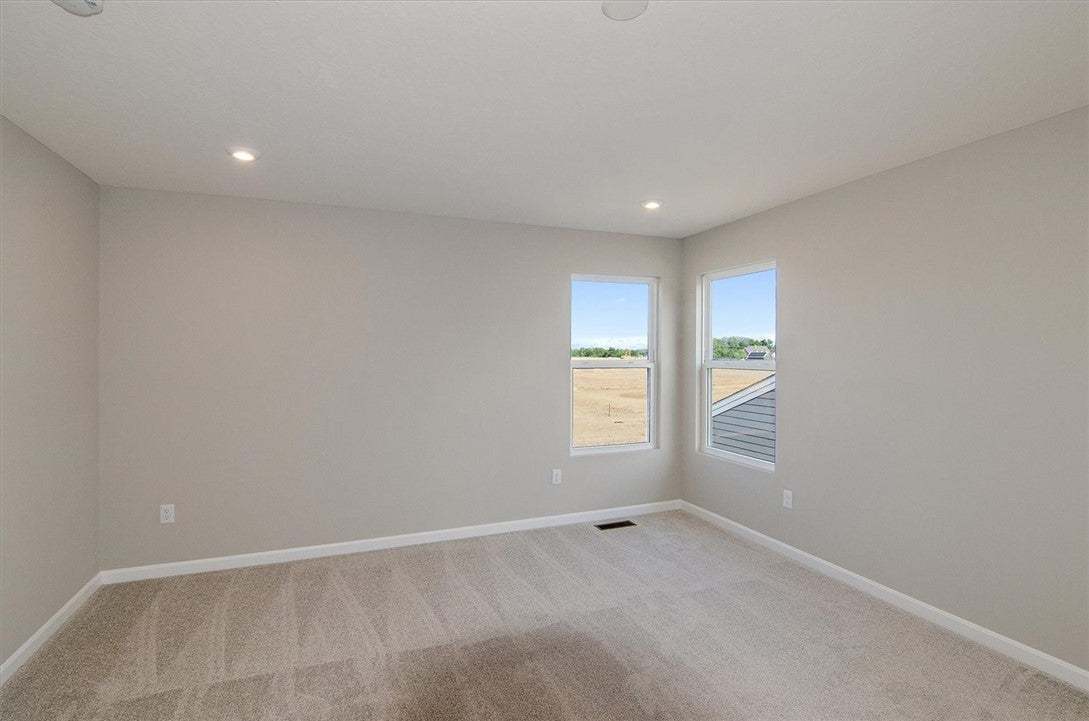 Plush carpeting and recessed lighting create a com