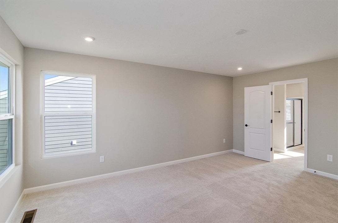 Recessed lighting and soft carpeting create a sere