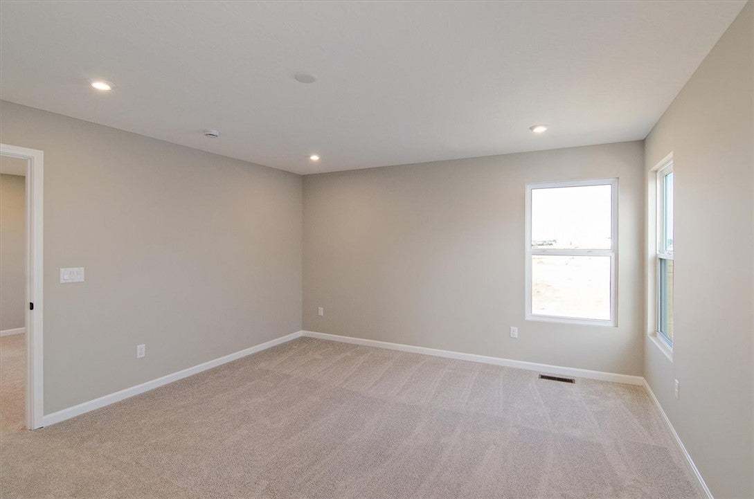 Recessed lighting and soft carpeting create a comf